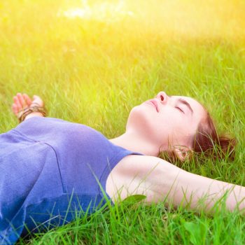 portrait of a young woman relaxing on a meadow
